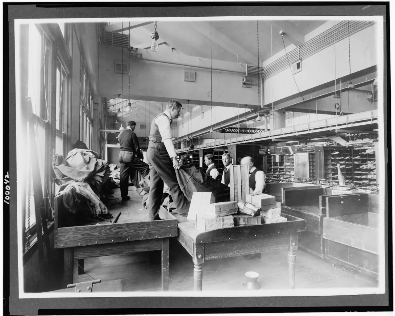 Title: Postal workers sorting mail, U.S. Post Office, Washington, D.C.] / National Photo Co., Washington, D.C Abstract/medium: 1 photographic. print.