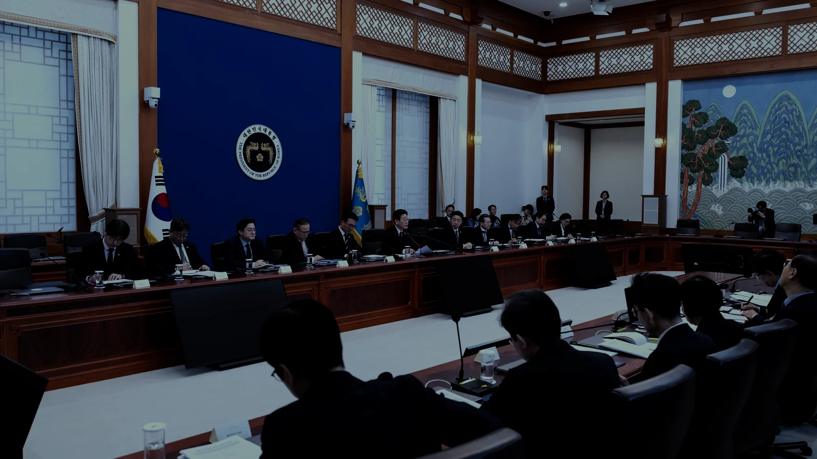Korean officials seated for an economic inspection meeting