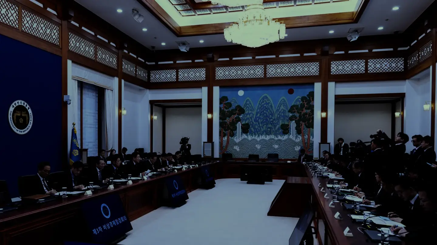 A wide government meeting room in session