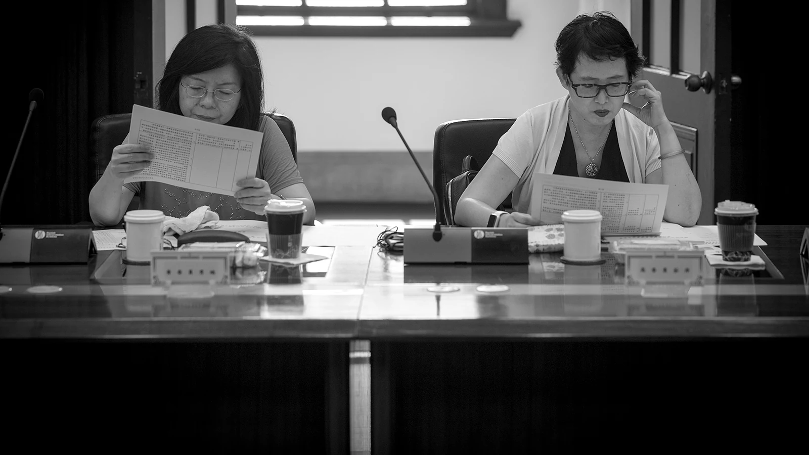 Officials read the papers at the committee bench