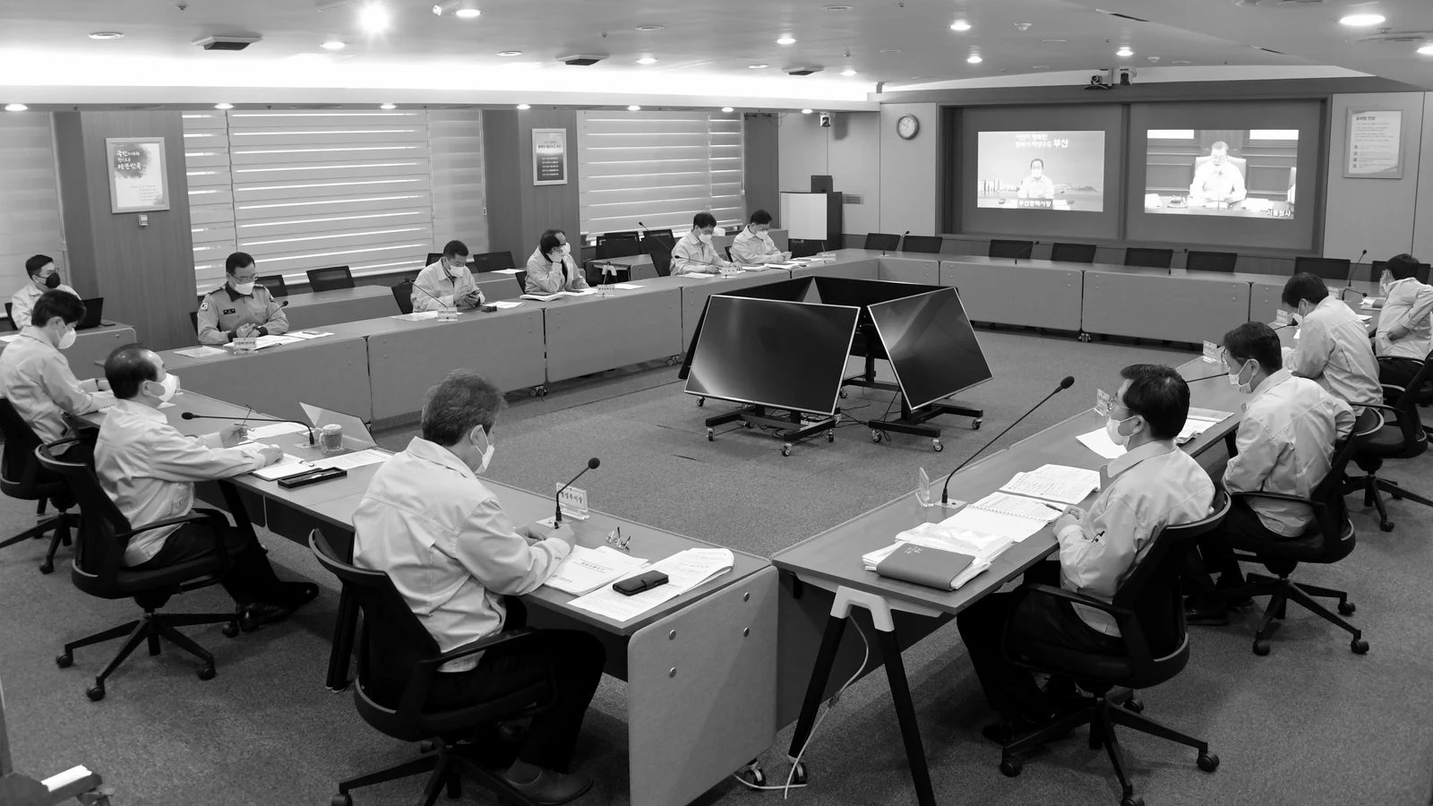 An operations room with desks and screens in use