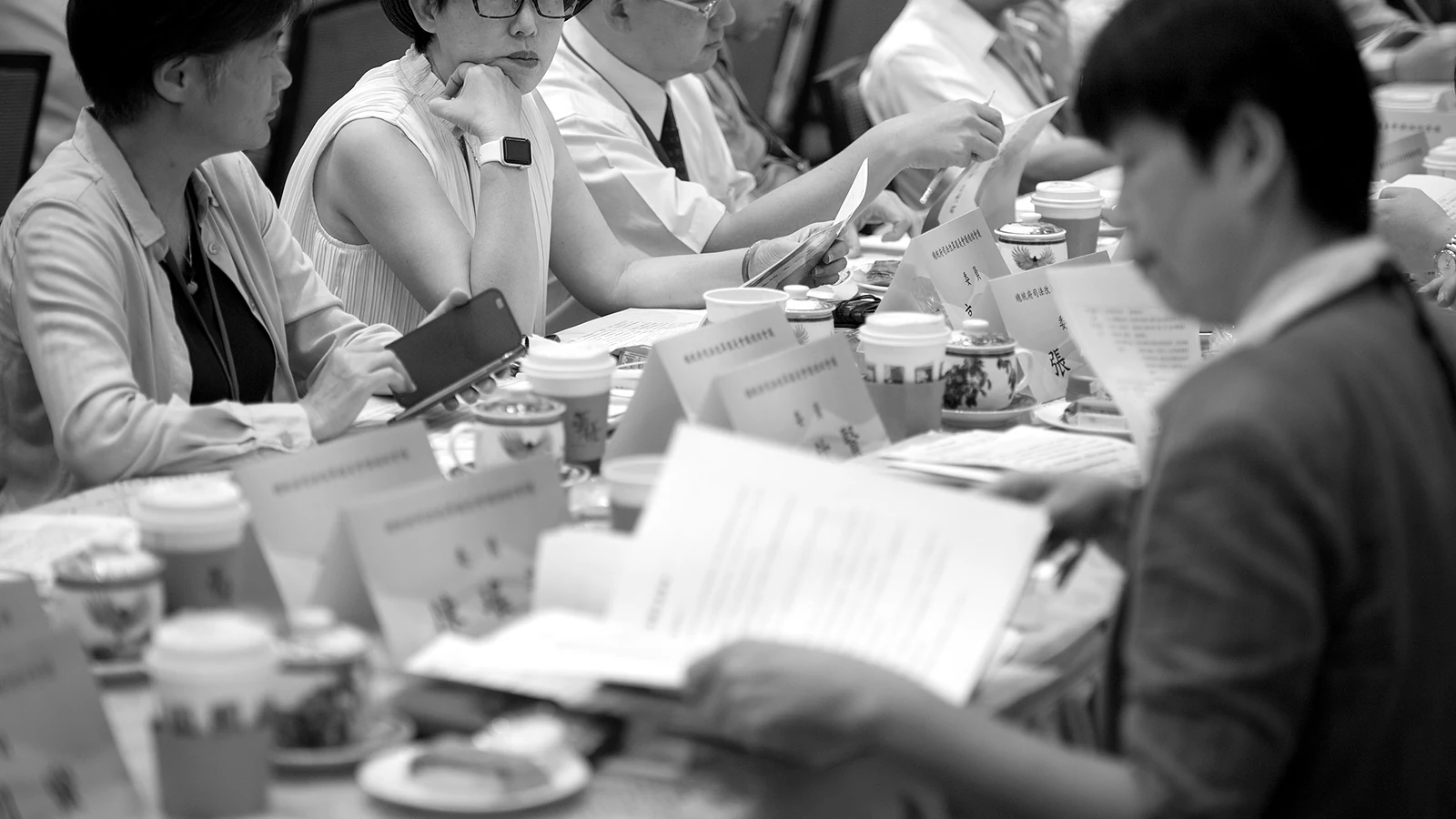 Papers passed across the table during a working session