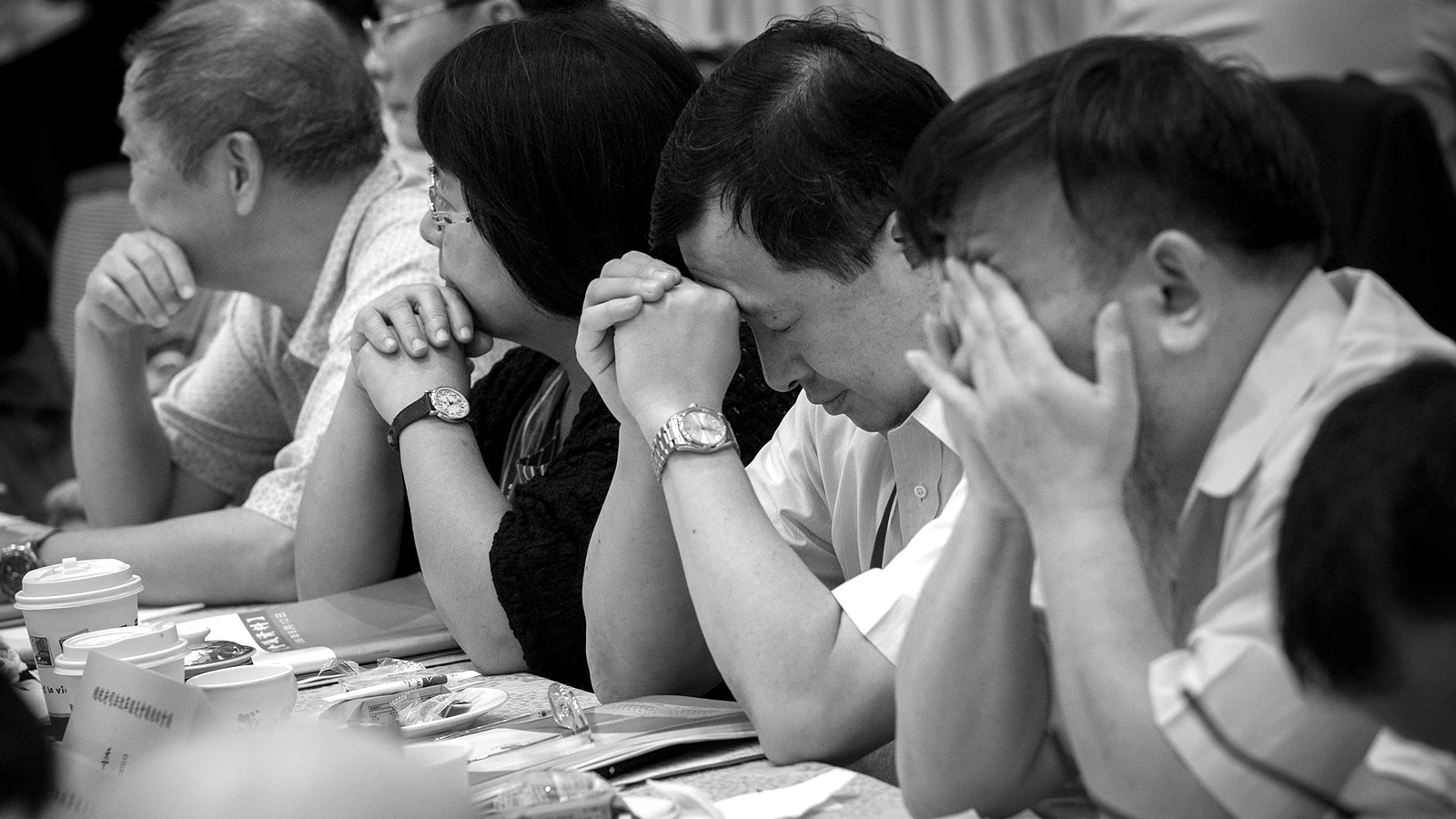 Attendees study the documents in front of them