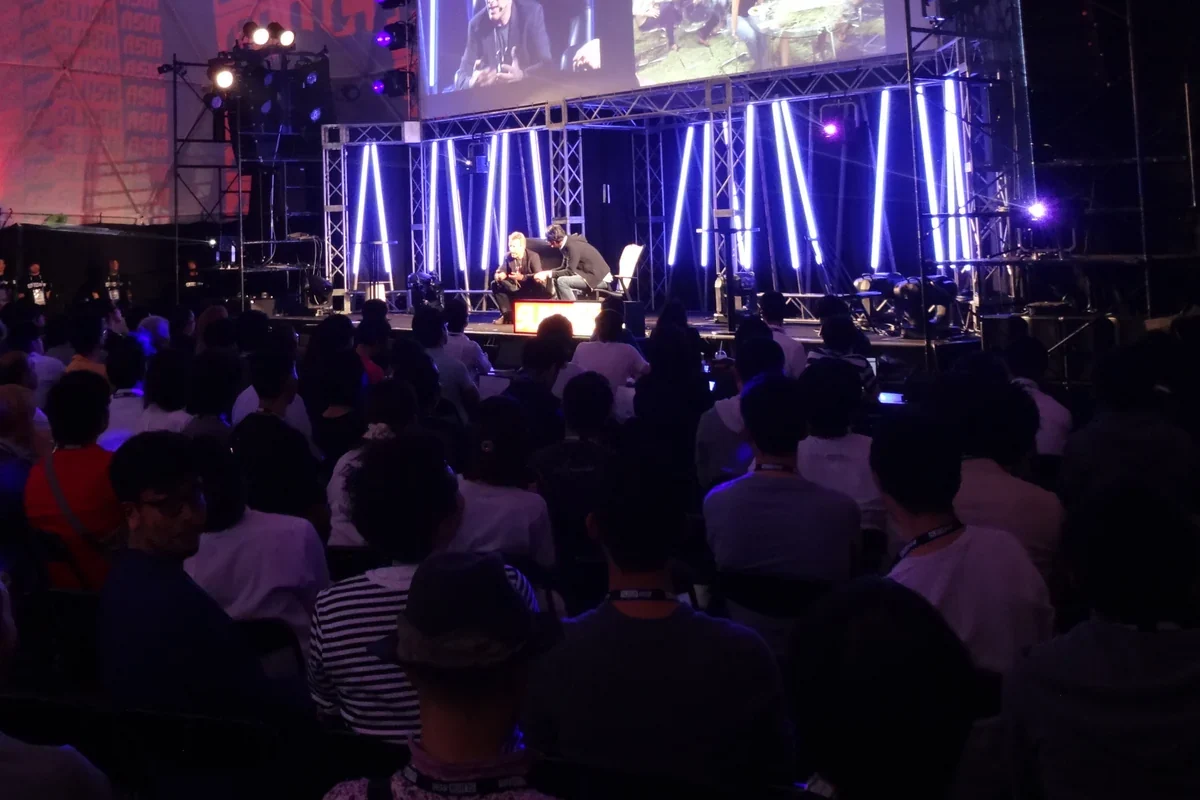 Audience facing the lit main stage in the Odaiba dome at Slush Asia 2015, Tokyo · editorial context