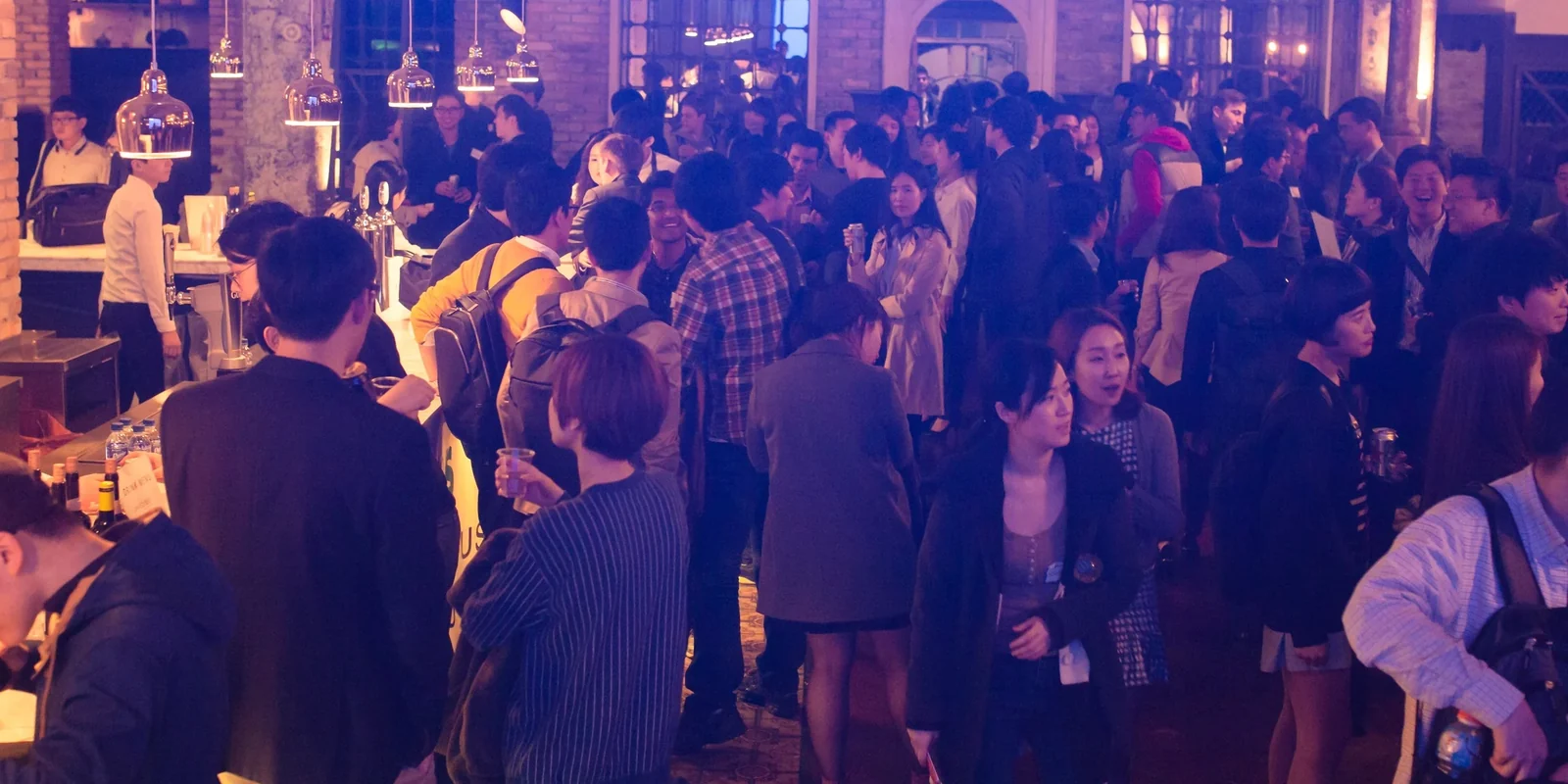 Attendees networking at the bar during TechCrunch Meetup + Pitch-off Seoul, April 2015 · editorial context
