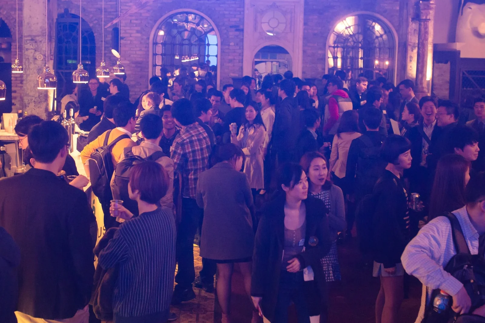 Attendees networking at the bar during TechCrunch Meetup + Pitch-off Seoul, April 2015 · editorial context