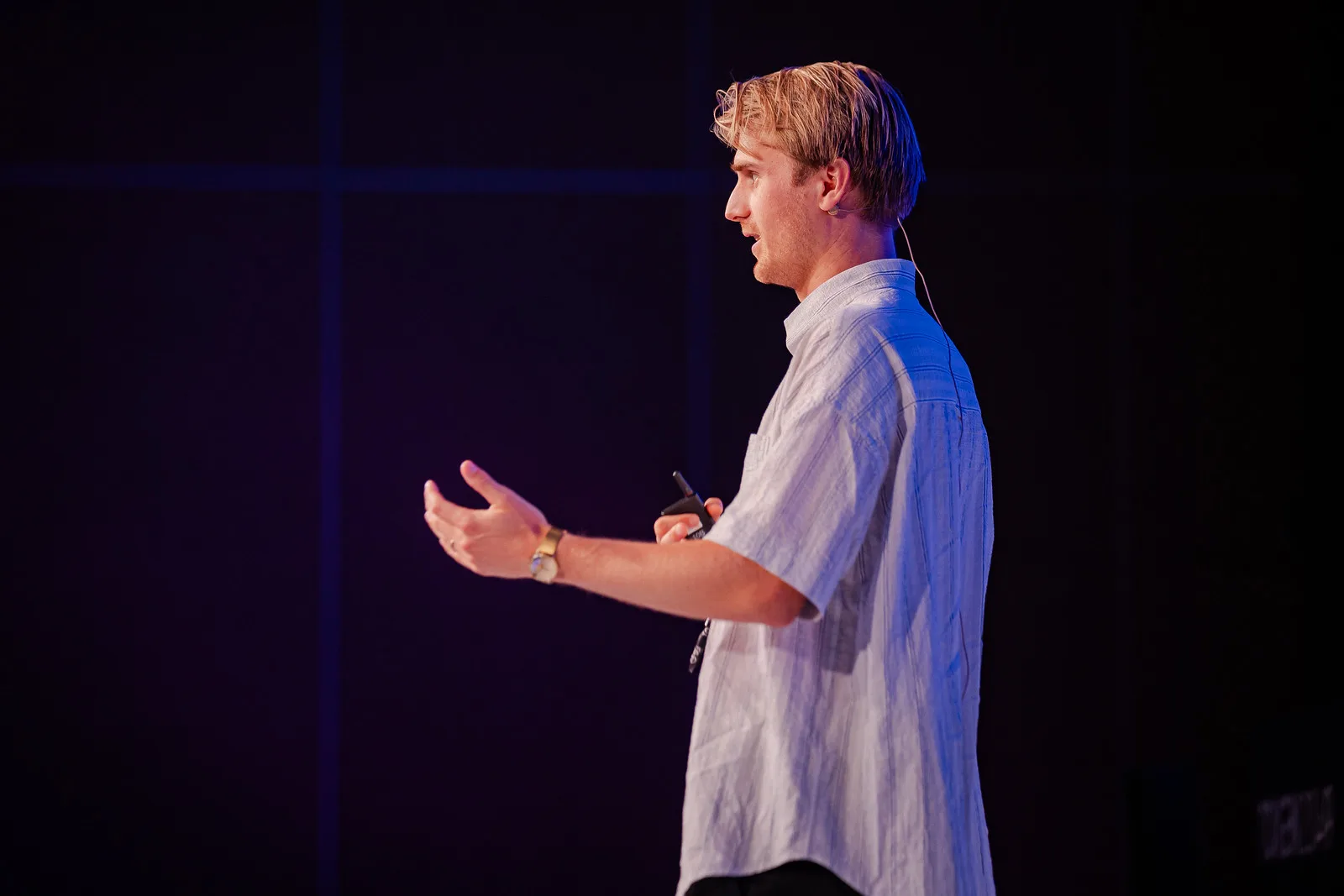 Speaker on a dark stage at TOKEN2049 Singapore 2023 · editorial context