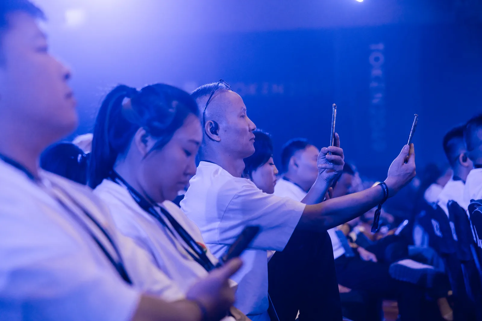 Audience filming a main-stage session at TOKEN2049 Singapore 2025 · editorial context